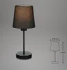 A black table lamp with a fabric shade is shown against a plain gray background. A technical drawing with dimensions is shown to the right. Produktbild-Vorschau