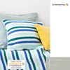 Crocheted pillows and a blanket with stripes in various shades of blue, green, and white, with a yellow pillow for contrast. Produktbild-Vorschau