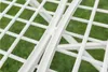 A close-up view of a white metal drying rack with a green grassy background. Náhled obrázku produktu