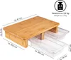A bamboo cutting board with two clear plastic pull-out trays underneath, shown from a slightly elevated side angle. Produktbild-Vorschau