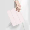 A person holding a pink tablet case. Produktbild-Vorschau