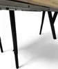 Close-up view of the underside of a table, showing its metal legs and extending mechanism. Produktbild-Vorschau