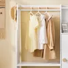 A close-up view of a children's wardrobe with clothes hanging on a rack. Anteprima dell’immagine prodotto