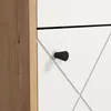 A close-up view of a white cabinet door with a black knob and a wood-grain side panel. Voir les images du produit