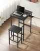 A black bar table and stool set on a wooden floor, with a laptop and coffee cup on the table. Produktbild-Vorschau