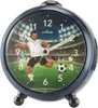 An alarm clock with a football theme, showing a player kicking a ball on a stadium background. Produktbild-Vorschau