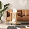 A modern living room scene with a couch, plant, and a side table. Produktbild-Vorschau
