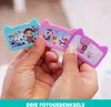 Hands holding three small, cat-shaped photo frames with cartoon characters inside. Produktbild-Vorschau