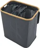 A dark gray laundry basket with a wooden rim and three internal compartments. Náhled obrázku produktu