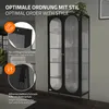 A black display cabinet with glass doors is shown in a room setting, with close-up insets highlighting features like the magnetic lock and adjustable feet. Náhľad obrázku produktu