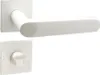 A white door handle set with a square rosette and a separate WC lock mechanism, presented against a plain white background. Produktbild-Vorschau