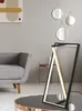 A modern living room scene with a grey sofa, a coffee table with a lamp, and decorative mirrors on the wall. Náhľad obrázku produktu