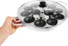A hand holding a poacher pan with a glass lid. Produktbild-Vorschau