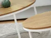 Close-up of two oval-shaped coffee tables with wooden tops and white legs. Náhľad obrázku produktu