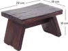 A dark brown wooden stool with dimensions indicated by measurement lines and text. Produktbild-Vorschau