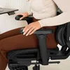 A person sitting in an office chair at a desk. Produktbild-Vorschau