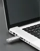 A close-up shot of a silver USB 3.0/3.1 flash drive plugged into the side of a white laptop. Anteprima dell’immagine prodotto