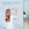 A woman is interacting with a white electric towel radiator in a bathroom setting. Voir les images du produit