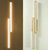 A modern, wooden LED ceiling light with two light tubes, shown on a white wall. Produktbild-Vorschau