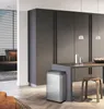 A modern kitchen or dining area with a stainless steel trash can, a table, and stools. Produktbild-Vorschau