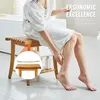 A person sitting on a wooden shower stool in a bathroom. Podgląd zdjęcia produktu