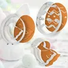 Easter-themed cookie cutters and decorated cookies, including egg and chick shapes, arranged with a plush bunny. Podgląd zdjęcia produktu