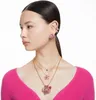 A woman wearing a pink sweater and jewelry. Náhľad obrázku produktu