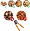 A collage of different types of nuts, some with checkmarks indicating suitability for a nutcracker, and others with 'X' marks indicating unsuitability. A nutcracker is shown in the foreground. Podgląd zdjęcia produktu