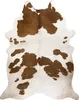 A cowhide rug with brown and white patches, laid flat against a white background. Náhled obrázku produktu