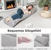 A woman is lying on a gray floor chair in a living room setting, with a fireplace and plants in the background. The image is divided into sections with text and close-up views of the product's features. Anteprima dell’immagine prodotto