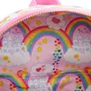 A close-up view of the inside lining of a Loungefly Care Bears backpack, featuring a whimsical pattern of rainbows, castles, clouds, and stars. Produktbild-Vorschau