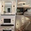 A collage of four images showing modern LED wall lights in different home settings: a bathroom, a bedroom, a living room with a TV, and a staircase. Anteprima dell’immagine prodotto