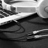 A close-up shot of a Ugreen audio cable plugged into a laptop, with headphones attached. Anteprima dell’immagine prodotto