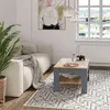 A living room scene with a couch, coffee table, and plant. Produktbild-Vorschau