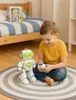 A young boy is playing with a robot in a bedroom. Anteprima dell’immagine prodotto