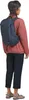 A person wearing a backpack and casual clothing. Produktbild-Vorschau
