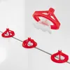 A set of red tile leveling spacers with a clear wedge insert, shown on a white tiled surface with gray grout lines. Produktbild-Vorschau