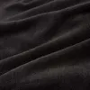 A close-up shot of black, soft fabric with visible folds and texture. Anteprima dell’immagine prodotto
