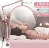 A woman is lying on a massage table while a half-moon LED lamp illuminates her face. A person's hands are gently touching her forehead. Náhľad obrázku produktu