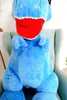 A large blue plush dinosaur toy sitting in a chair. Náhled obrázku produktu