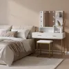 A bedroom scene with a bed and a vanity table. Produktbild-Vorschau