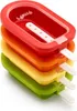 A stack of four colorful popsicle molds in red, orange, yellow, and green, with white popsicle sticks protruding. Produktbild-Vorschau