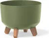 A green planter with wooden legs on a white background. Náhled obrázku produktu
