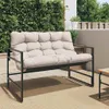 A garden bench with cushions on a patio next to a green wall. Náhled obrázku produktu