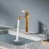 A close-up shot of a retro-style bronze faucet with a white ceramic handle, running water into a marble sink. Podgląd zdjęcia produktu