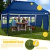 A family is enjoying a meal under a blue pop-up gazebo in a grassy backyard. Anteprima dell’immagine prodotto