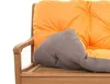 A close-up view of an orange and gray cushion on a wooden bench. Produktbild-Vorschau
