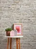 A small round table with decorative items against a stone wall background. Produktbild-Vorschau