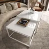 A modern living room with a curved sofa, a coffee table set, and a decorative vase with dried flowers. Produktbild-Vorschau