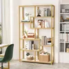 A gold-colored bookshelf with faux marble shelves is filled with books and decorative items. A green chair and a desk are partially visible on the left. Produktbild-Vorschau